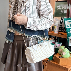 White Boston bag with geometric pattern, golden butterfly buckle and chain strap