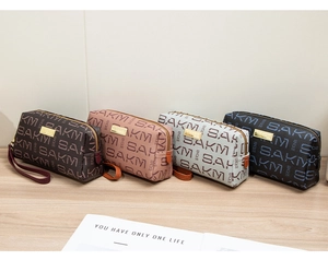 Row of four premium leather clutches in coffee, pink, blue, and navy with logo plates