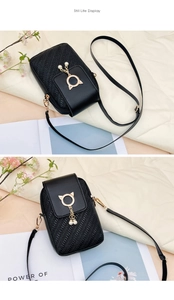 Détail du mini sac bandoulière noir tissé avec décor oreilles de chat et pompon perlé