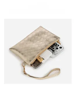 Champagne gold quilted clutch bag showing inner capacity for phone and essentials