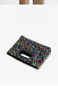 Detail view of vibrant multi-color sequins and rectangular cutout handle on the square bag
