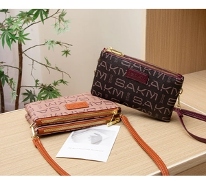 Detail of multi-layer zipper crossbody bags with letter print and golden hardware