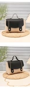 Detail of woven straw handbag with black leather flap and golden metal buckles