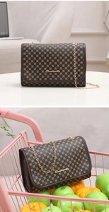 Close-up of the vintage brown crossbody bag with gold chain strap in a lifestyle setting