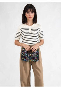 Detail of colorful sequin square clutch bag featuring a sleek black rectangular handle