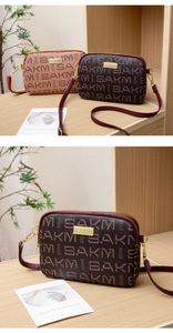 Close-up of vintage patterned crossbody bags with dual zippers and gold logo plates