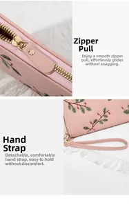 Detail of premium gold metal zipper and pink leather wrist strap on embroidered wallet