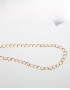 Close-up of polished gold metal chain strap showing high-quality oval link texture