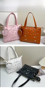 Detailed embroidery and quilted texture on large faux leather tote bags with matching pouches