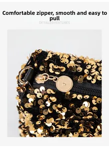 Detailed close-up of smooth golden circular zipper on black sequined fashion handbag