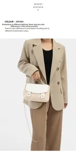 Detail of woven straw handbag with white leather flap and gold chain on model