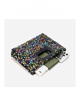 Internal view of sequin handbag showing capacity for phone, wallet and keys