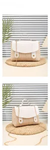 Detail of cream woven handbag with white leather flap and gold chain strap in home setting