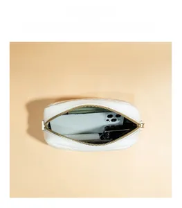 Interior view showing the capacity of this white quilted crossbody camera bag