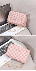 Detail view of pink flap chain bag with retro geometric print and gold metal strap