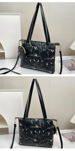 Detail of floral embroidery on black leather tote bag with matching round coin purse