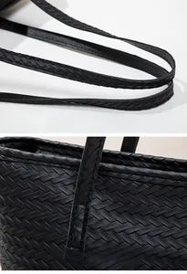 Detail of black woven leather tote bag showing soft handles and fine stitching quality