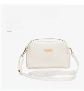 White chevron quilted camera bag with adjustable straps and gold-tone metal plaque