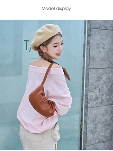 Brown ruched crescent bag shoulder carry view on model with high quality faux leather detail