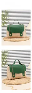 Detail of woven straw handbag with green leather trim and gold chain strap features