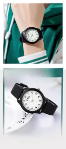 Minimalist quartz watch with black silicone strap shown in lifestyle and product views
