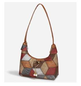 Detail view of contrast patchwork underarm bag with faux crocodile and snake textures