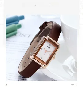 Detailansicht einer roségoldenen rechteckigen Uhr mit braunem Lederarmband