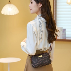Retro brown crossbody bag for women with double zipper and gold hardware in daily use