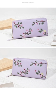 Detailed embroidery of lavender floral patterns on a long zipper wallet for women