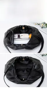 Detailed interior of black pleated dumpling bag showing spacious storage and magnetic clasp