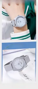 Detail of grey silicone watch strap and clean white minimalist dial for women