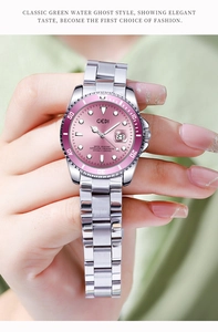 Close-up of pink diving watch with rotating bezel and date window on steel band