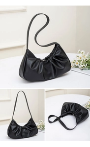 Three-view montage of black pleated crescent shoulder bag in soft matte vegan leather