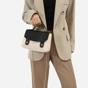 Beige woven crossbody bag with black leather flap and gold chain strap in chic summer style