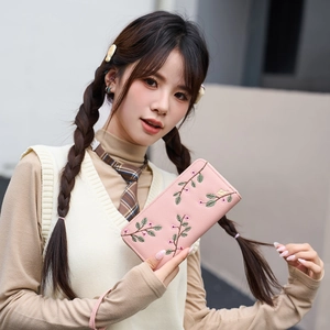 Pink faux leather long wallet with floral embroidery and secure zipper closure for women