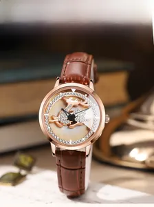 Detail of rose gold watch featuring a 3D deer dial with crystals and brown leather strap