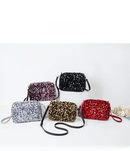 Close-up of colorful sequin mini square bags in five metallic shades on geometric stands