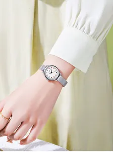 Detail of a ladies quartz watch with colorful crystal markers and silver mesh strap