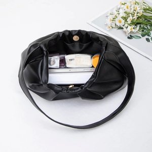 Chic black pleated cloud bag with spacious interior shown from a top-down view