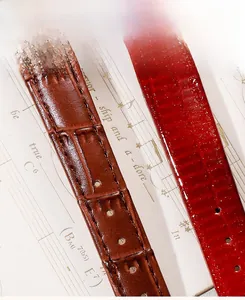 Detailed macro view of premium leather watch straps with brown and red embossed textures