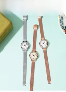 Macro detail of GEDI minimalist watches with colorful markers and Milanese mesh straps