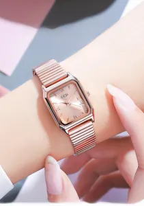Detail of GEDI rectangular rose gold watch with elastic metal band and Roman numerals