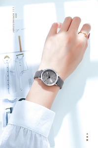 Close-up of elegant ladies quartz watch with grey leather strap on a model's wrist