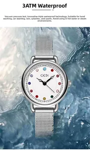 Close-up of GEDI watch dial with colorful rhinestones on flowing blue water surface