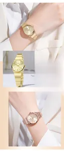 Detail showing elegant gold and rose gold quartz watches with bamboo style steel bands