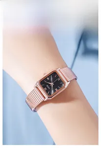 Elegant rose gold square quartz watch with black roman dial worn on a female wrist