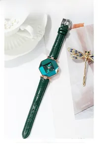 Detail of GEDI quartz watch with green hexagonal crystal face and rose gold case
