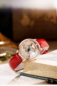 Macro shot of rose gold women watch with 3D deer dial on vintage books background