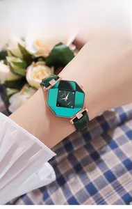 Detail of a green octagonal watch with rose gold rhinestones and leather strap
