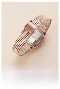 Detailed macro view of the rose gold mesh band and stainless steel watch case back